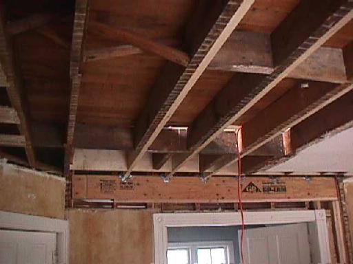 closer view of new ceiling joists and new header supporting the house above over the double door