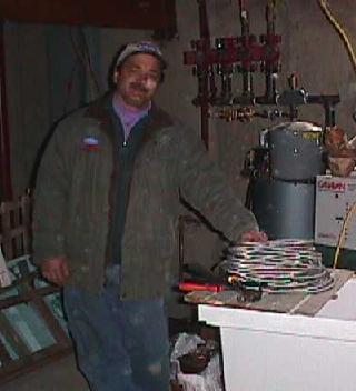 Heating guy Pete standing beside the boiler he has accessorized