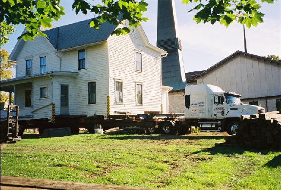 The truck cab hooked up to the house, which sports the mandatory 
 lights, flags and corner reflectors.