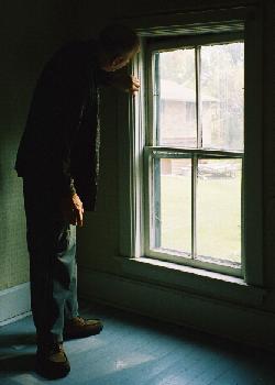 Brian looks at window whose upper sash is at an angle