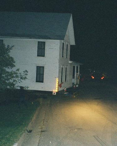 house being pulled up over the curb, off the street