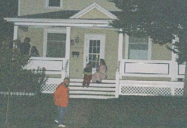 Neighbors along the route in pyjamas, slippers and bathrobes watch from their front porches