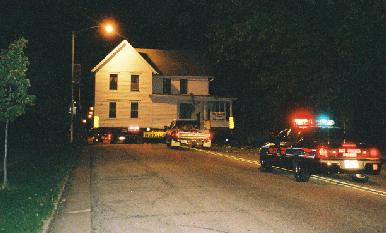A police car takes up the rear as the house heads westbound