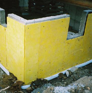 waterproofing insulation pressed against the outside of the foundation