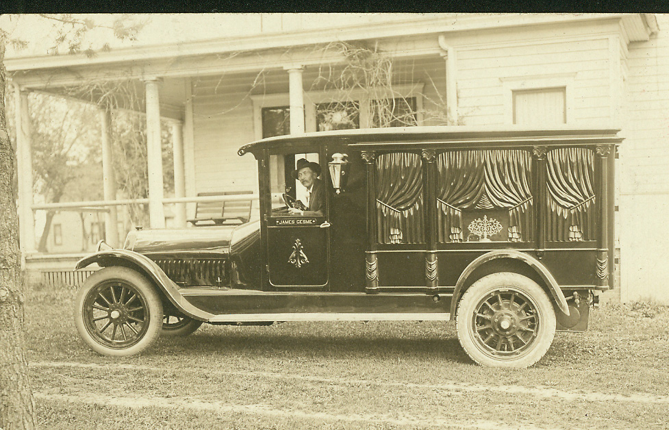 The Gesmes' motorized hearse beside the house